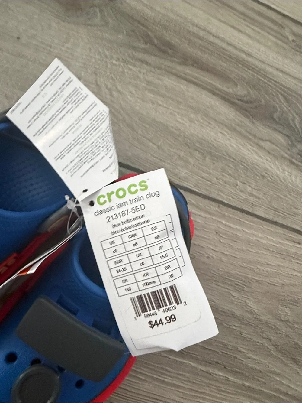 CROCS Kids Clog in Blue with Red Trim and Black Badges